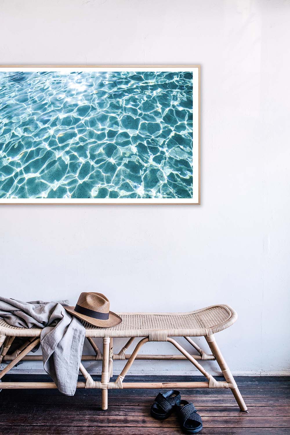 Lucky Stars by DANIELLEX, turquoise pool water print above a rattan bench